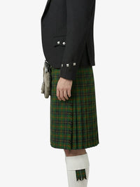 Person wearing a black jacket and green plaid kilt on a white background
