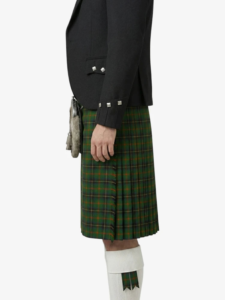 Person wearing a black jacket and green plaid kilt on a white background