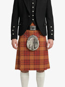 Person wearing a traditional Scottish kilt with a black jacket on a white background