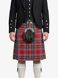 Person wearing a black jacket with decorative buttons, a red plaid kilt, and a sporran on a white background.
