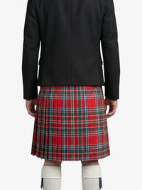 Person wearing a black coat and red plaid kilt on a white background