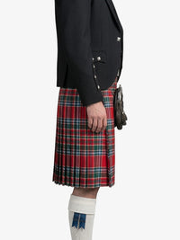 Person wearing a black jacket and red plaid kilt on a white background