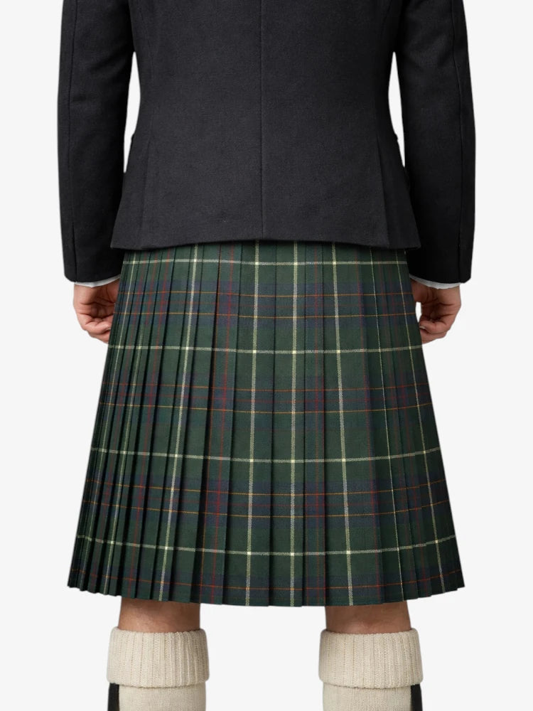 Person wearing a dark jacket and green plaid kilt on a white background