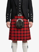 Person wearing a red tartan kilt with a black jacket on a white background