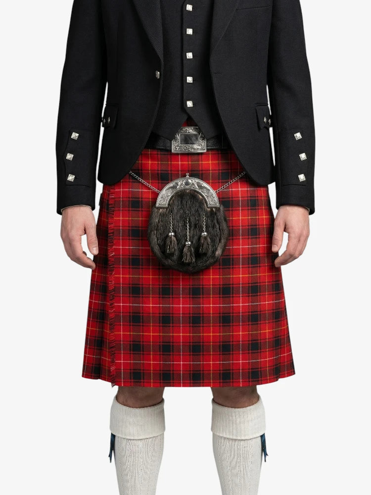 Person wearing a red tartan kilt with a black jacket on a white background