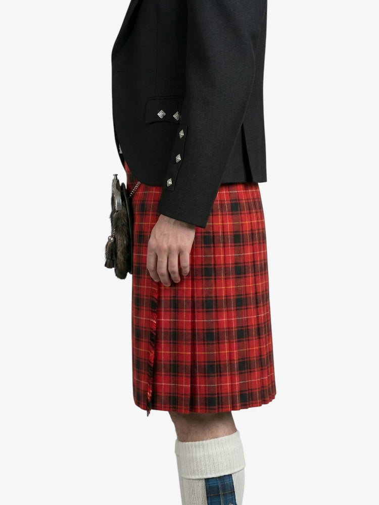 Person wearing a black jacket and red plaid kilt on a white background