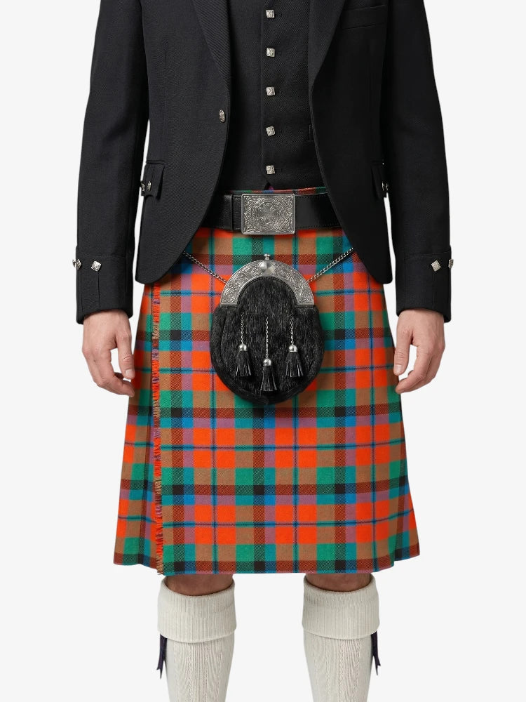 Person wearing a traditional Scottish kilt with a tartan pattern on a white background