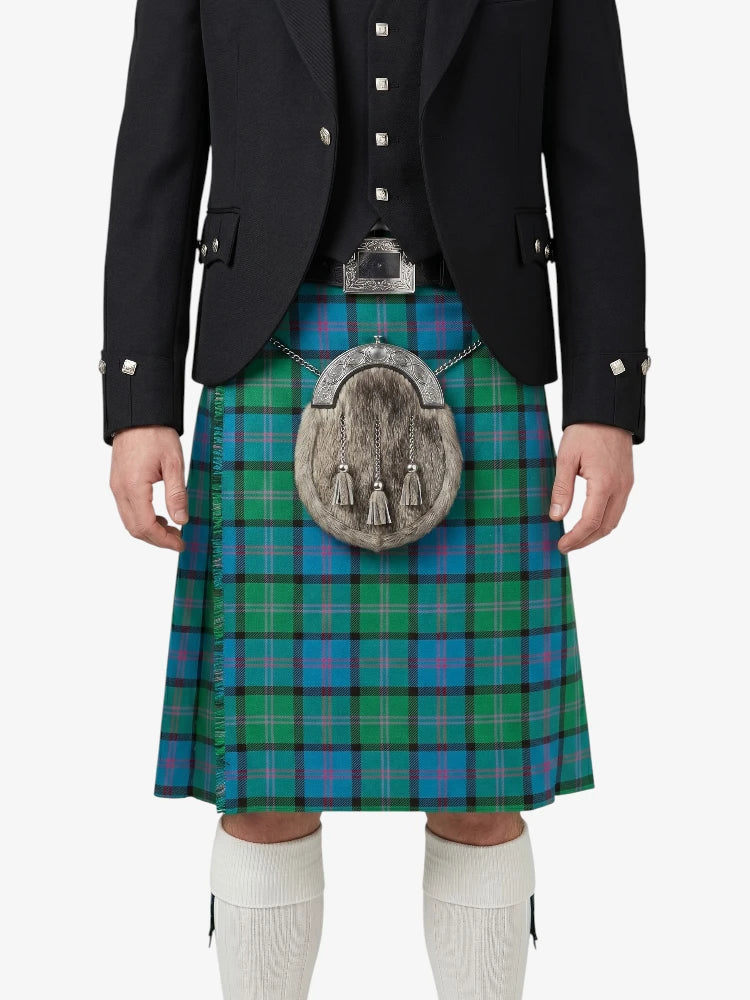 Person wearing a traditional Scottish kilt with a tartan pattern on a white background