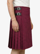 Maroon pleated kilt with black belt on a white background