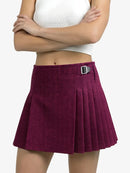 Purple pleated skirt worn by a person on a white background