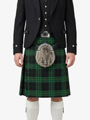 Person wearing a traditional Scottish kilt with a tartan pattern on a white background