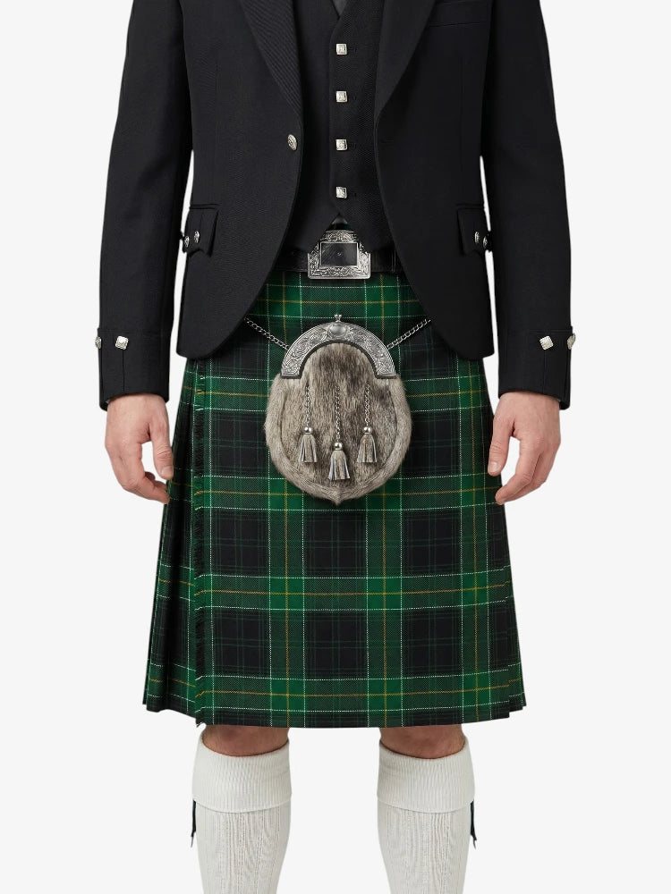 Person wearing a traditional Scottish kilt with a tartan pattern on a white background