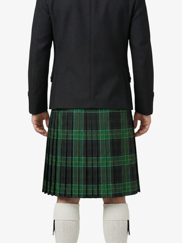 Person wearing a black coat and green plaid kilt on a white background