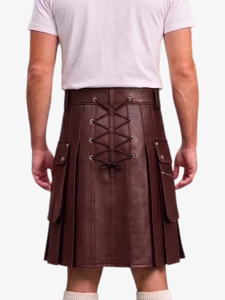 A man wearing a dark brown faux-leather kilt with a lace-up back, side pockets, and pleated front panels, paired with a white t-shirt and white socks.