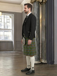 Man wearing a traditional kilt in an elegant interior setting