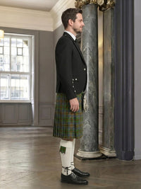 Man wearing a traditional Scottish kilt in an elegant interior setting