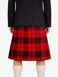 Red plaid kilt worn with a black coat on a white background