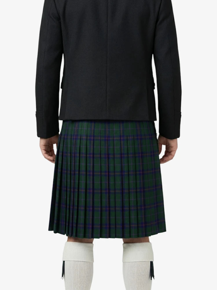 Person wearing a black jacket and plaid kilt on a white background