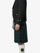 Person wearing a black jacket and green plaid kilt on a white background