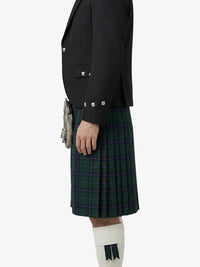 Person wearing a black jacket and green plaid kilt on a white background