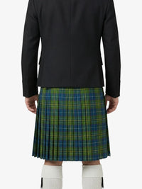 Person wearing a black jacket and green plaid kilt on a white background