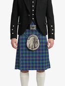 Person wearing a black jacket and blue plaid kilt with a silver sporran on a white background