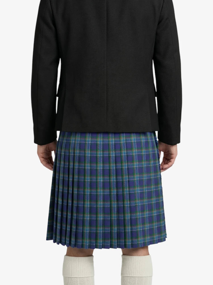 Person wearing a black coat and blue plaid kilt on a white background