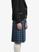 Person wearing a black jacket and blue plaid kilt on a white background