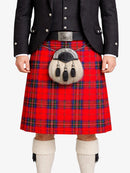 Person wearing a red tartan kilt with a black jacket on a white background