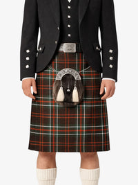 Person wearing a traditional Scottish kilt with a tartan pattern on a white background