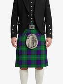 Person wearing a green and purple plaid kilt with a black jacket on a white background