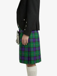 Person wearing a black jacket and green plaid kilt on a white background
