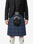 Person wearing a traditional Scottish kilt with a sporran on a white background