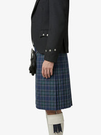 Person wearing a black blazer and blue plaid kilt on a white background