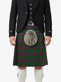 Person wearing a traditional Scottish kilt with a tartan pattern on a white background