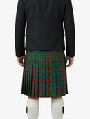 Person wearing a black jacket and green plaid kilt on a white background