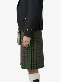 Person wearing a dark jacket and green plaid kilt on a white background