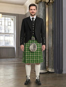 Man wearing a traditional Scottish kilt in a room with a large mirror.