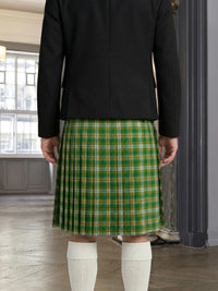 Person wearing a green plaid kilt indoors