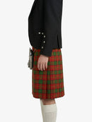 Person wearing a black jacket and red plaid kilt on a white background