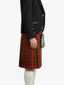 Person wearing a black blazer and red plaid kilt on a white background