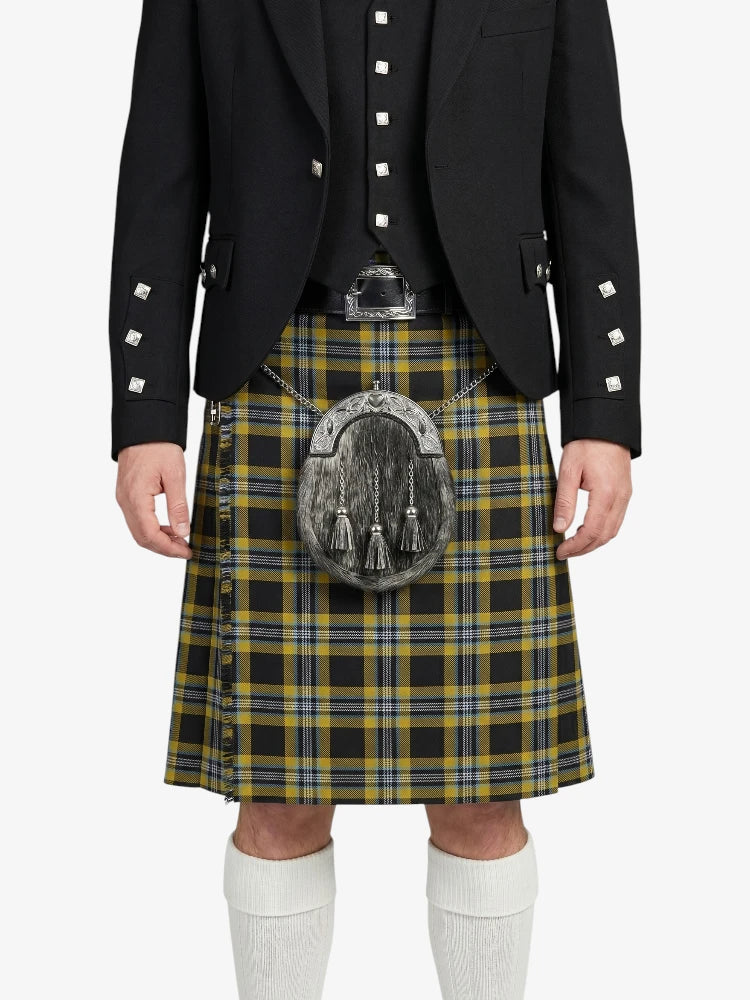 Person wearing a traditional Scottish kilt with a jacket on a white background