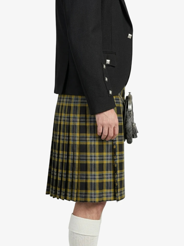 Person wearing a black jacket and plaid kilt on a white background