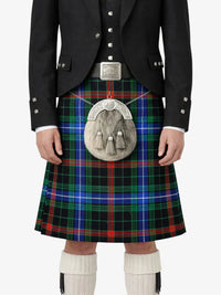 Person wearing a traditional Scottish kilt with a tartan pattern on a white background