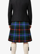 Person wearing a black jacket and plaid kilt on a white background