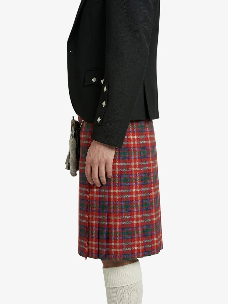 Person wearing a black jacket and red plaid kilt on a white background