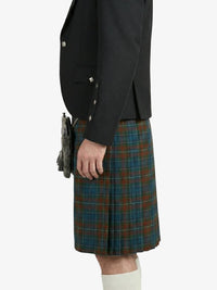 Person wearing a black jacket and a plaid kilt on a white background