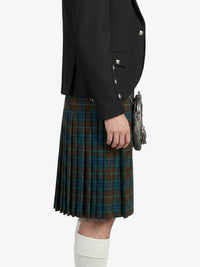 Person wearing a black jacket and plaid kilt on a white background