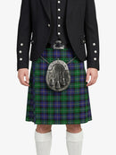 Person wearing a black jacket and green plaid kilt with a silver sporran on a white background