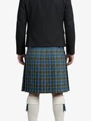 Person wearing a black jacket and blue plaid kilt on a white background